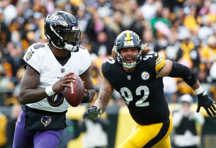 Oct 8, 2023; Pittsburgh, Pennsylvania, USA; Baltimore Ravens quarterback Lamar Jackson (8) scrambles with the ball against the Pittsburgh Steelers during the fourth quarter at Acrisure Stadium. Mandatory Credit: Charles LeClaire-USA TODAY Sports